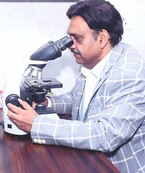 Dr Samir Gupta at the microscope