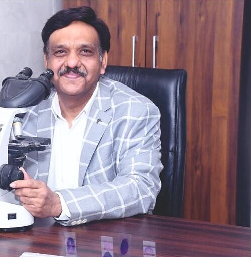 Dr Samir Gupta at his microscope